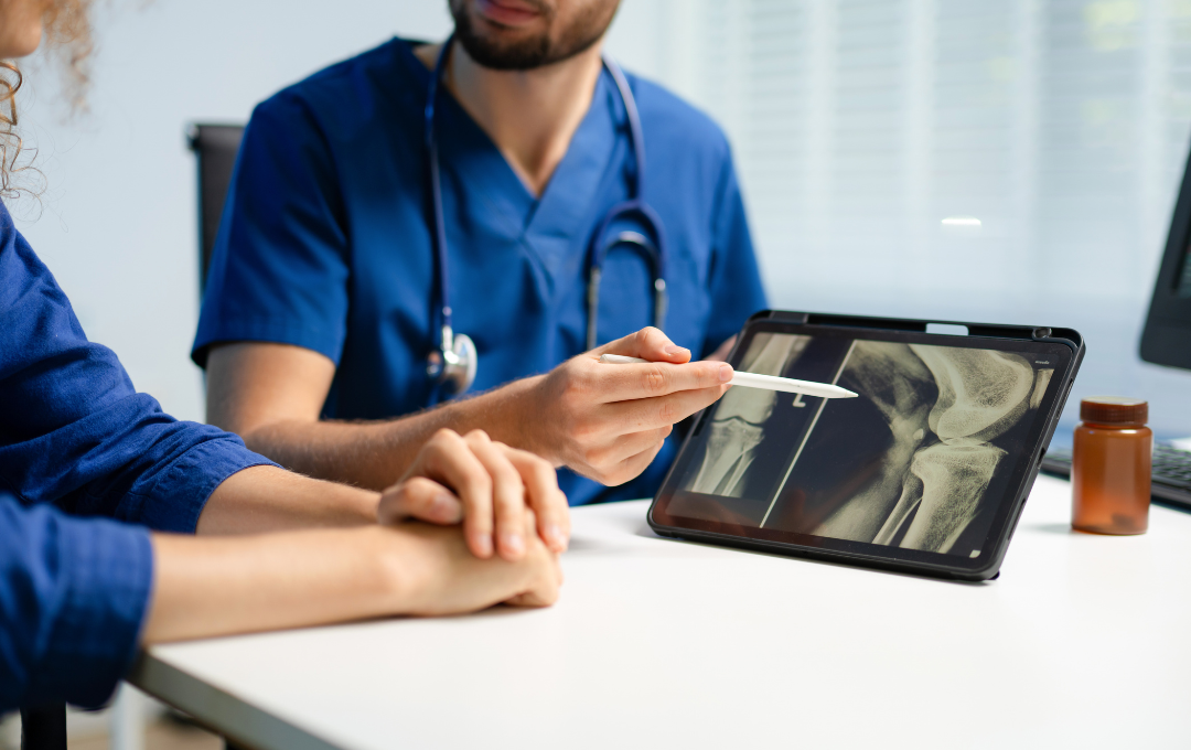 Knee specialist with patient going through knee scans.