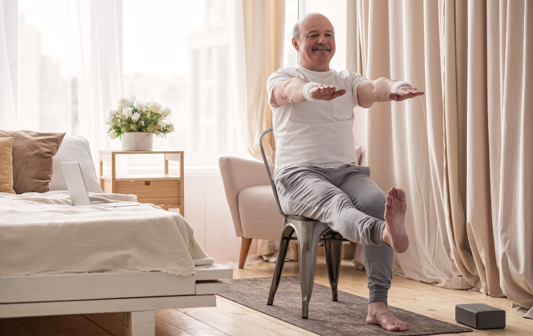 Older man doing leg raises at home for knee pain.