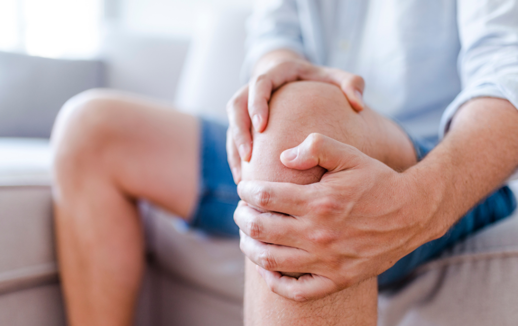 Man holding knee due to pain