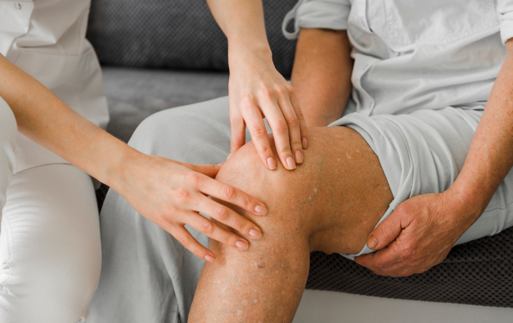 Person gripping the inner side of their knee in discomfort while seated