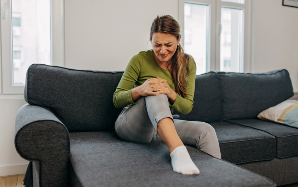 Woman holding her knee in pain.